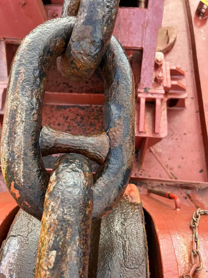 Anchor chain link inspected on deck