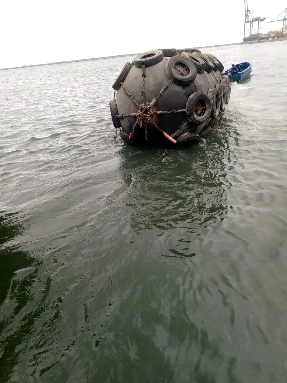 Pneumatic fender floating alongside a quay