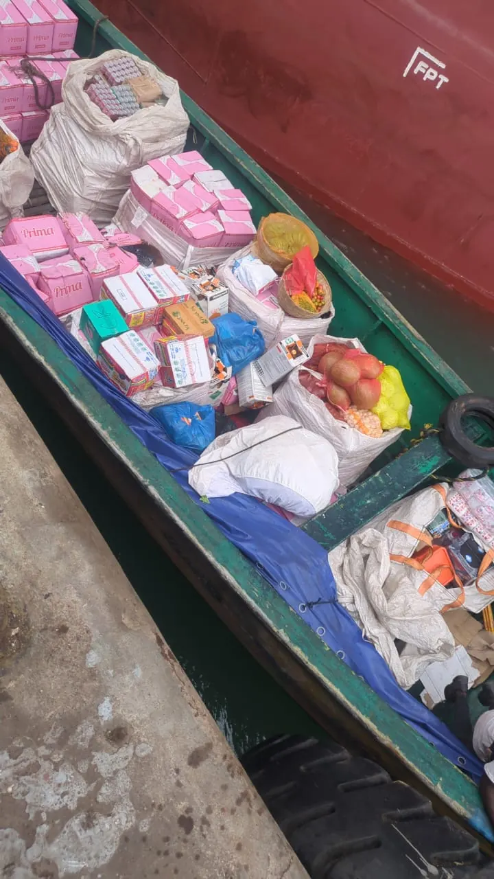Launch alongside a vessel with boxes of provisions
